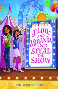 Two girls at a fairground next to a sign that says "Flor and Miranda Steal the Show" by Jennifer Torres.