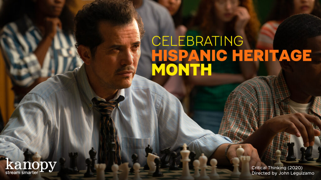Man playing chess with people watching; text: “Celebrating Hispanic Heritage Month.”.