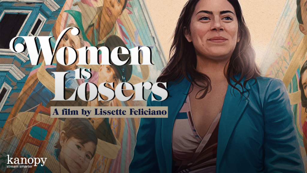 Smiling woman stands in front of murals with the text “Women Is Losers, A film by Lissette Feliciano.”.
