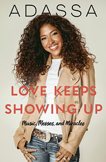 Smiling woman with curly hair in tan jacket; text reads “Love Keeps Showing Up: Music, Messes, and Miracles.”.