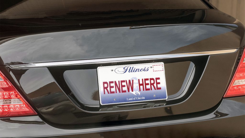 A car with an Illinois license plate that reads "RENEW HERE.