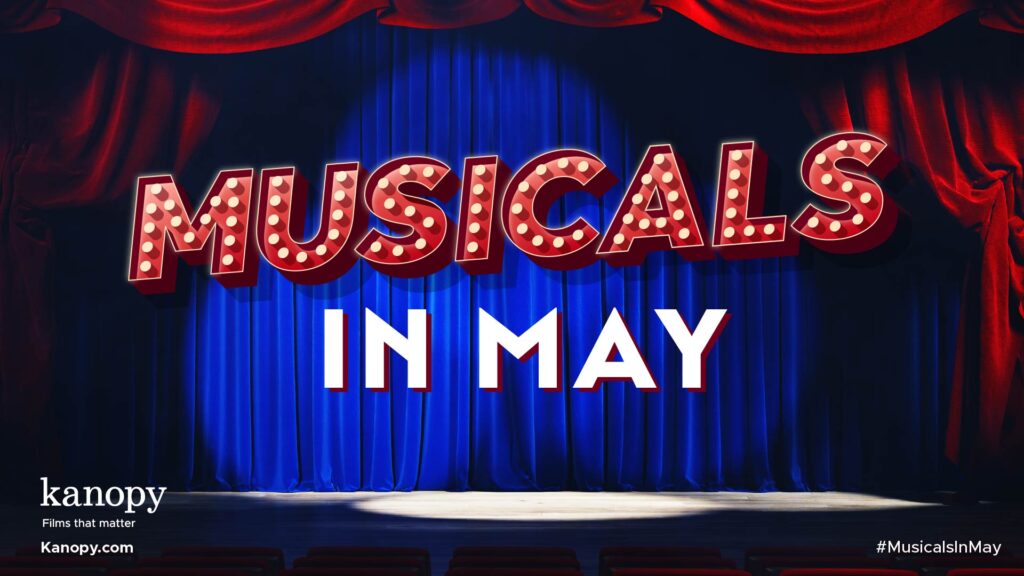 Theater stage with red curtains and blue backdrop, displaying "MUSICALS IN MAY" in bright, bold letters. Kanopy logo.