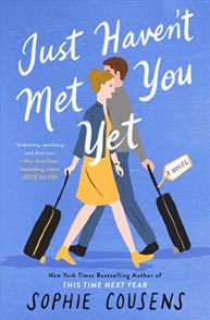 Book cover: "Just Haven't Met You Yet" by Sophie Cousens, featuring a couple walking with suitcases against a blue background.