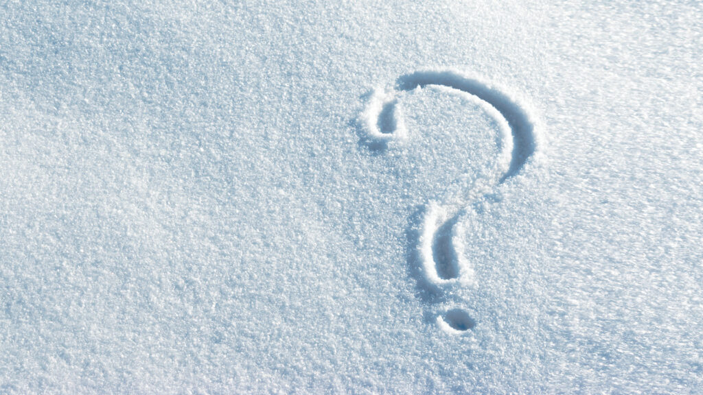 A question mark drawn in fresh, untouched snow.