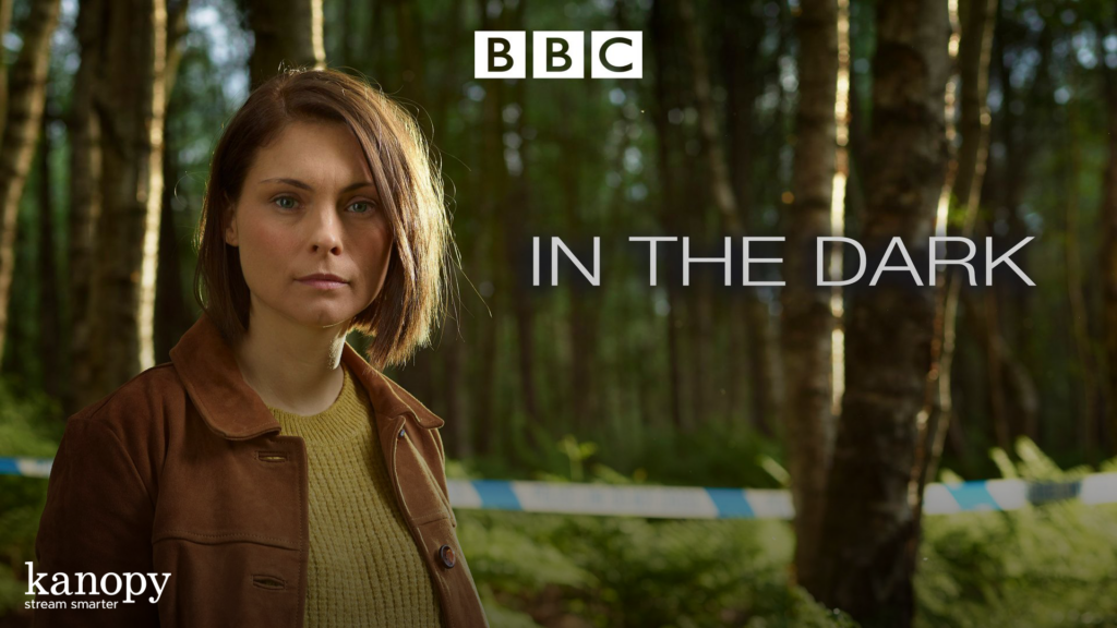 A woman stands in a forest with "BBC IN THE DARK" text and a Kanopy logo overlaid.