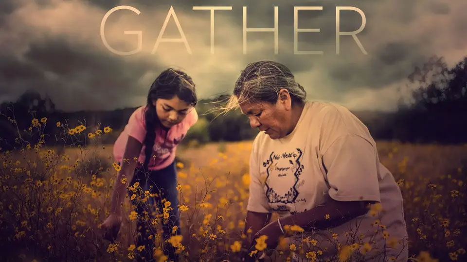 Two women gather yellow wildflowers in a field under a cloudy sky with the word “GATHER” above them.