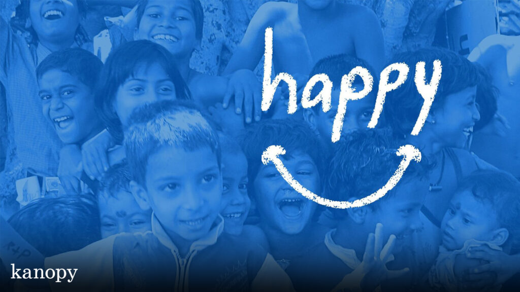 A group of smiling children with the word "happy" and a smiley face drawn over the image.