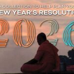 A person in orange robes sits outdoors at sunset with “2026” and New Year's resolution text overlaid.