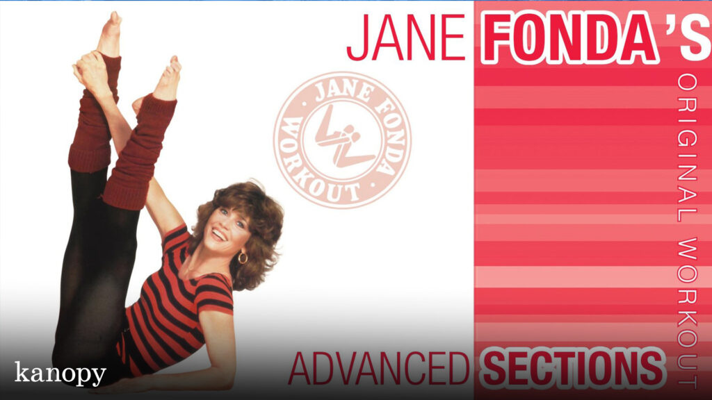 Jane Fonda poses in workout clothes with legs raised, advertising her original advanced workout video.