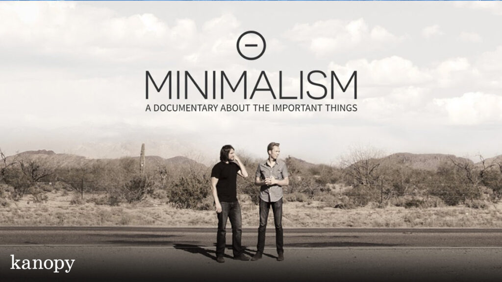 Two men stand on a road in front of a desert landscape under the "Minimalism" documentary title.
