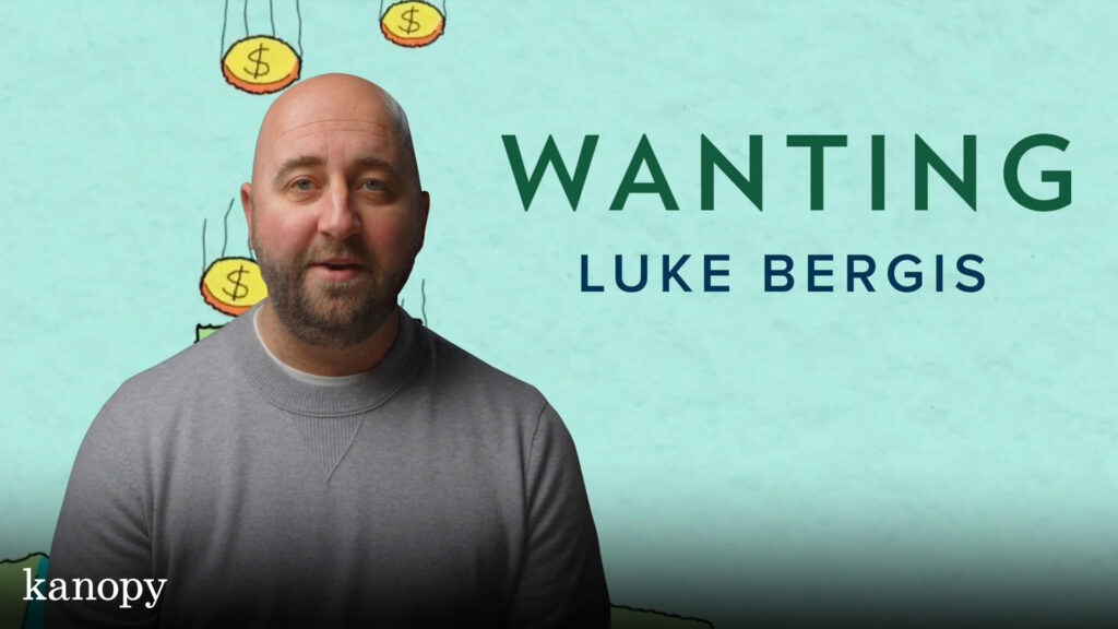 A man in a gray sweater stands in front of text reading "Wanting Luke Bergis" with cartoon coins above.