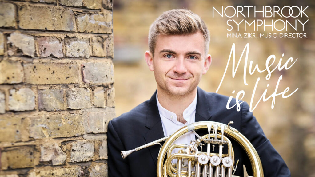 A man in a suit holds a French horn by a brick wall with the text "Music is life" and "Northbrook Symphony.