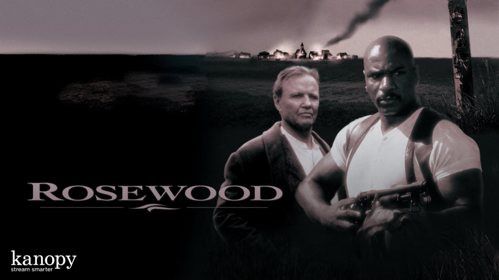 Two men stand in front of burning buildings with smoke, with "Rosewood" and "kanopy" text displayed.