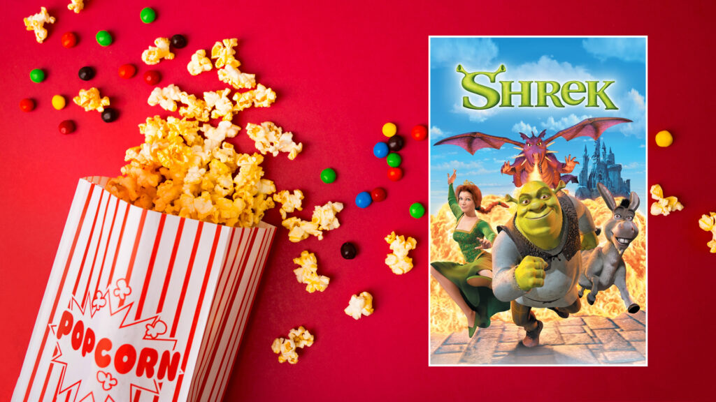 Popcorn and candy spilled on a red background next to the Shrek movie poster.