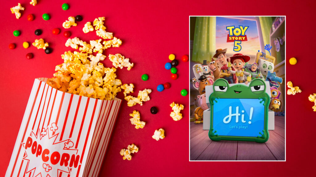 Popcorn and candy spill next to a poster for Toy Story 5 featuring toys and a blue "Hi! Let's play!" tablet.