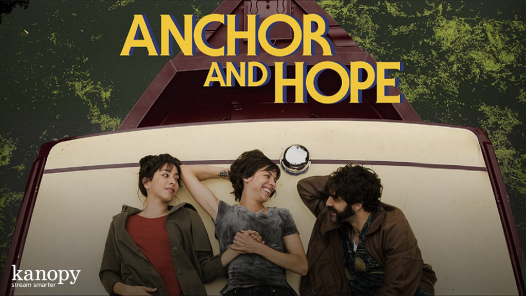 Three people relax on a boat deck, smiling, with "Anchor and Hope" in large yellow letters above them.