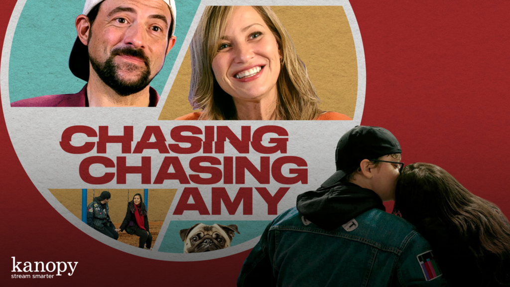 A couple kisses in front of a film poster with smiling people and the title “Chasing Chasing Amy.”.