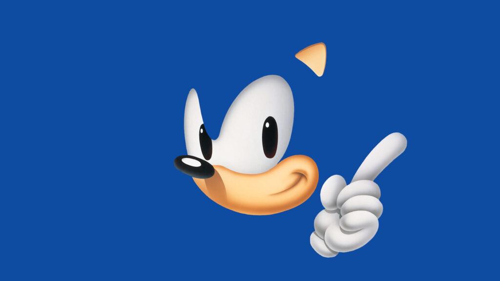 Sonic the Hedgehog smiling and pointing upward with one finger against a blue background.