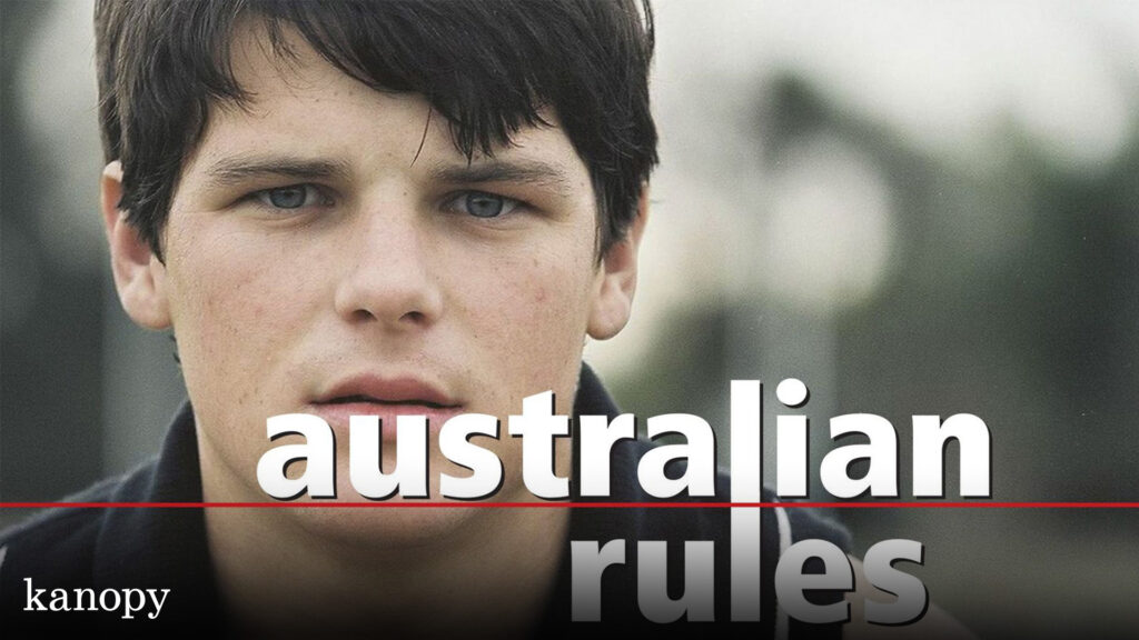 A close-up of a young man with dark hair; text reads "australian rules" and "kanopy" in the corner.