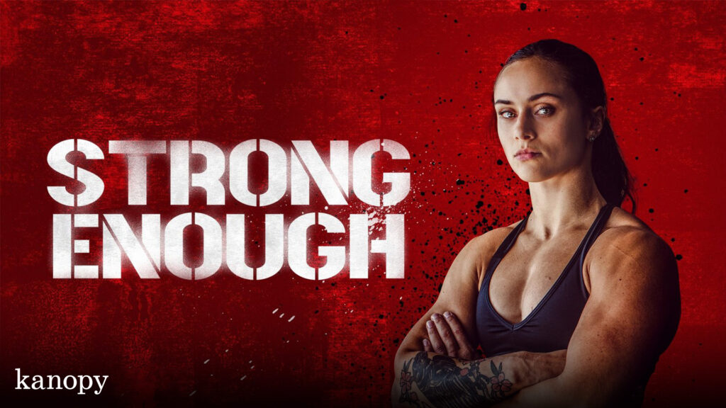 A muscular woman stands confidently with arms crossed beside the text "STRONG ENOUGH" on a red background.