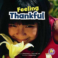 A child with black hair smiling and holding a yellow flower, under the text "Feeling Thankful.