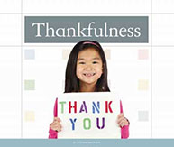 Young girl holding a "Thank You" sign, text above reads "Thankfulness." She is smiling against a light backdrop.