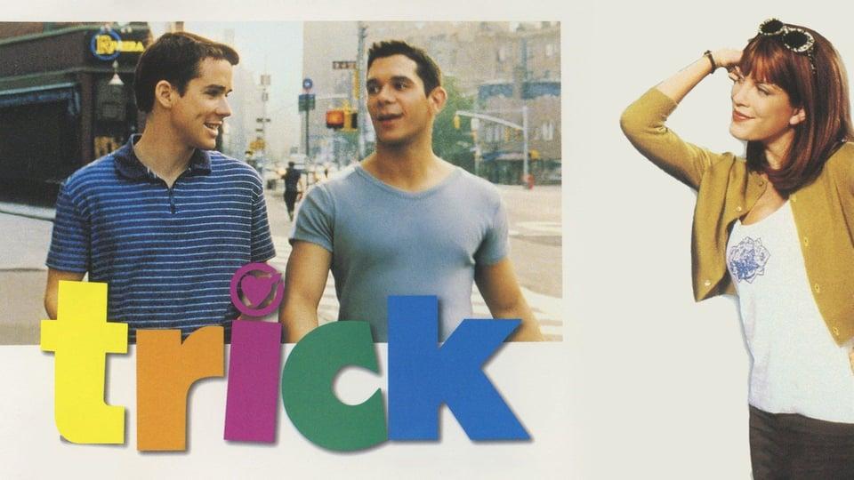 Two men walk on a street; the word "trick" is colorful, with a woman posing to the right.