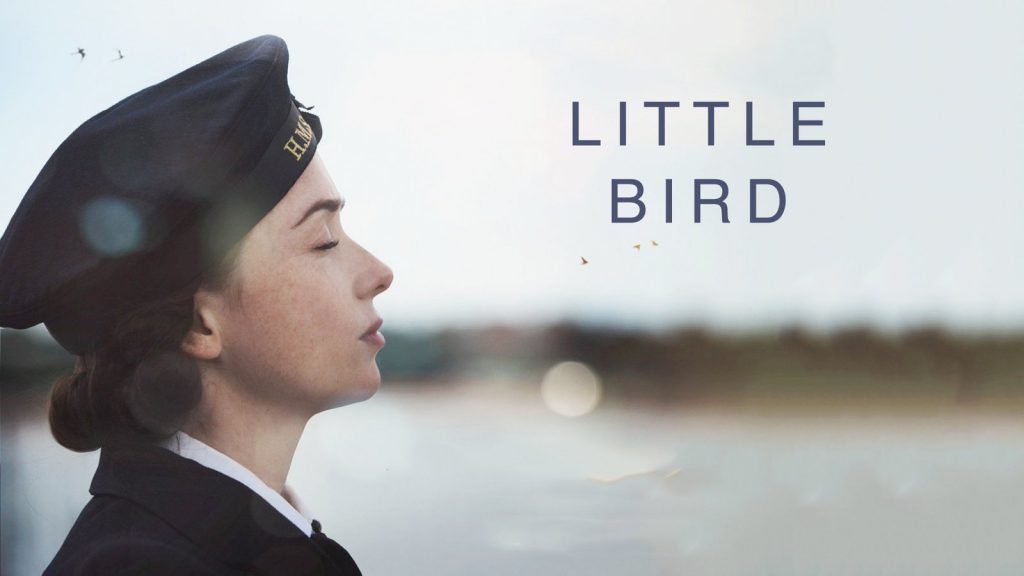 A woman in a hat with her eyes closed, set against a blurred background, with text "LITTLE BIRD.