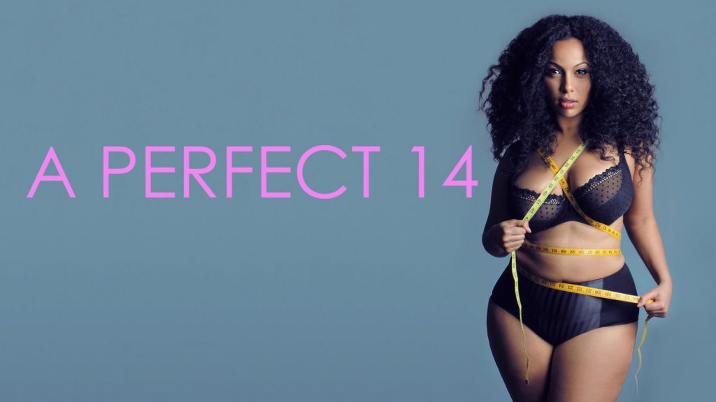 A woman wearing black lingerie holds a measuring tape around her body. Text reads "A PERFECT 14.