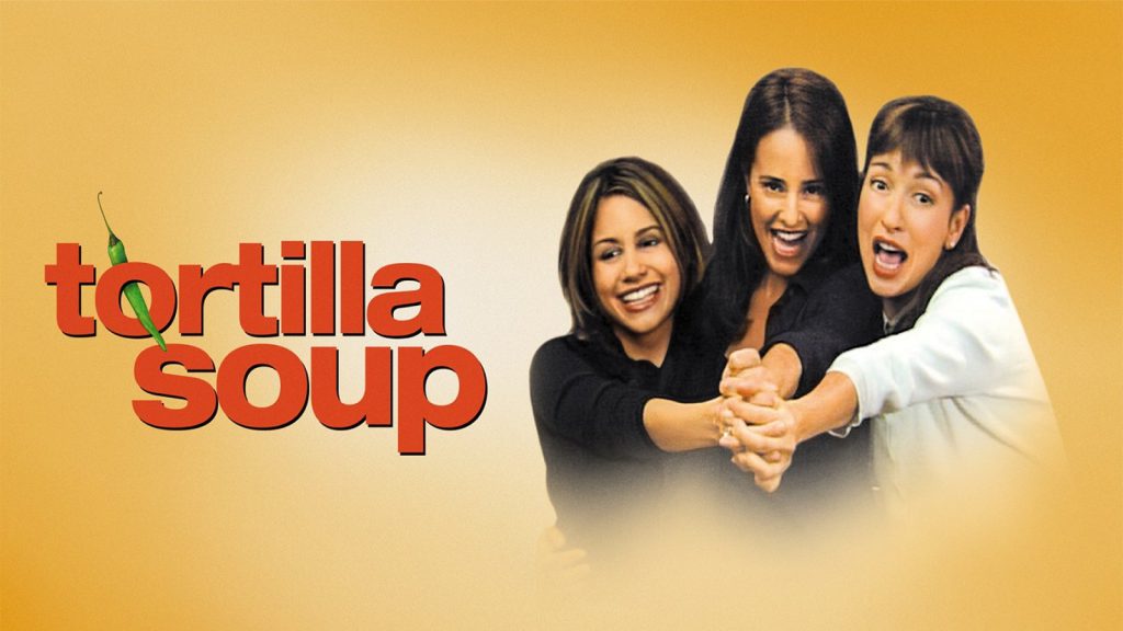 Three women smiling and holding hands in the movie poster of "Tortilla Soup" against a yellow background.